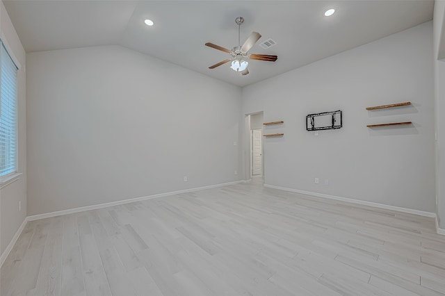 empty room featuring ceiling fan, light hardwood / wood-style floors, and vaulted ceiling