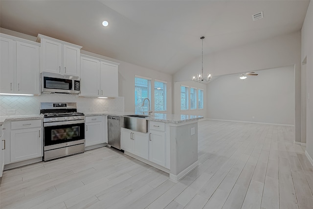 kitchen with white cabinetry, sink, lofted ceiling, and appliances with stainless steel finishes