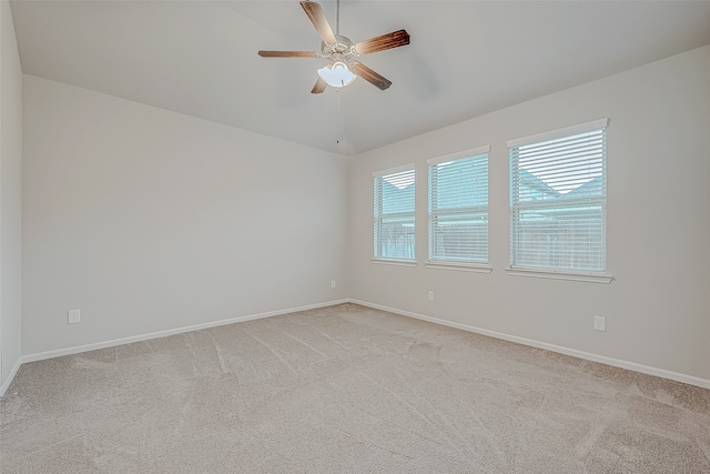 unfurnished room with ceiling fan and light colored carpet