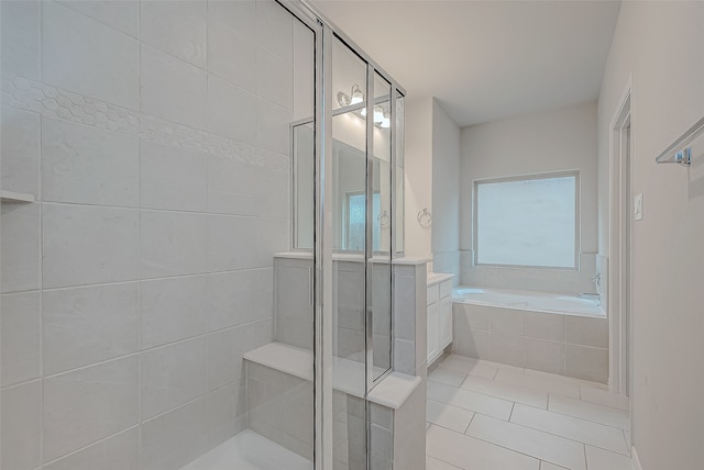 bathroom with tile patterned floors and separate shower and tub