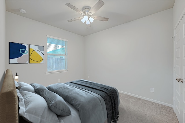 bedroom with ceiling fan and light carpet