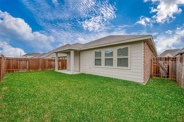 back of house with a lawn