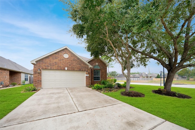 view of front of home featuring a front yard and a garage