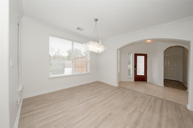 foyer featuring crown molding, light hardwood / wood-style flooring, and a chandelier