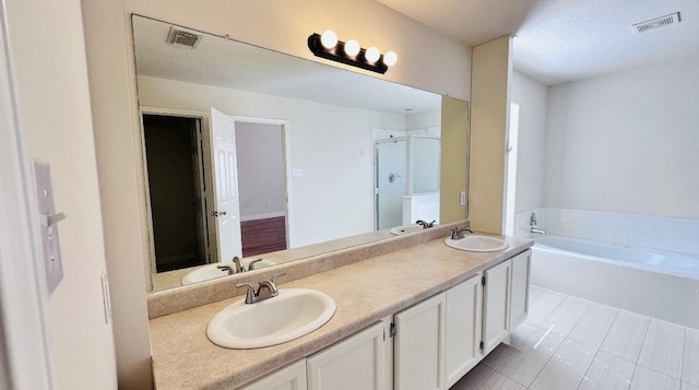 bathroom featuring separate shower and tub and vanity