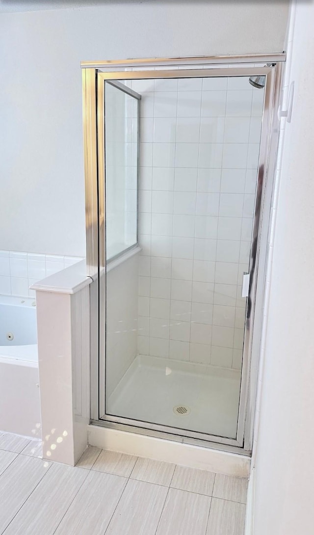 bathroom with tile patterned floors and independent shower and bath