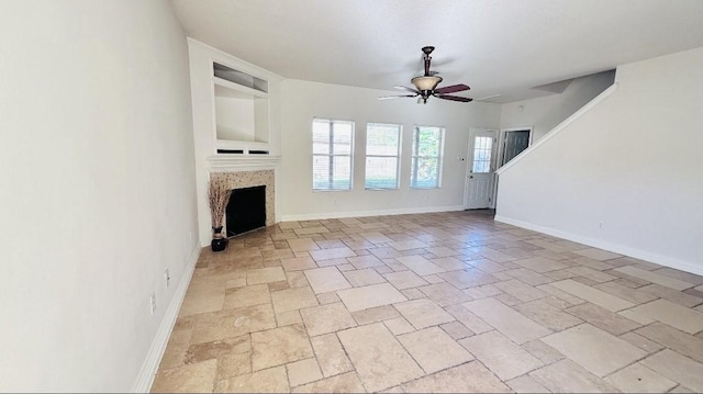 unfurnished living room featuring ceiling fan