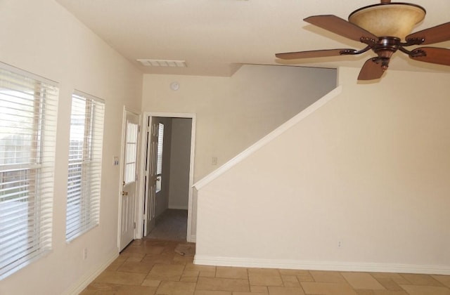 foyer entrance with ceiling fan