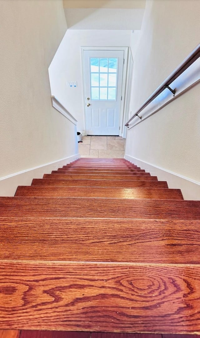 stairway featuring tile patterned floors