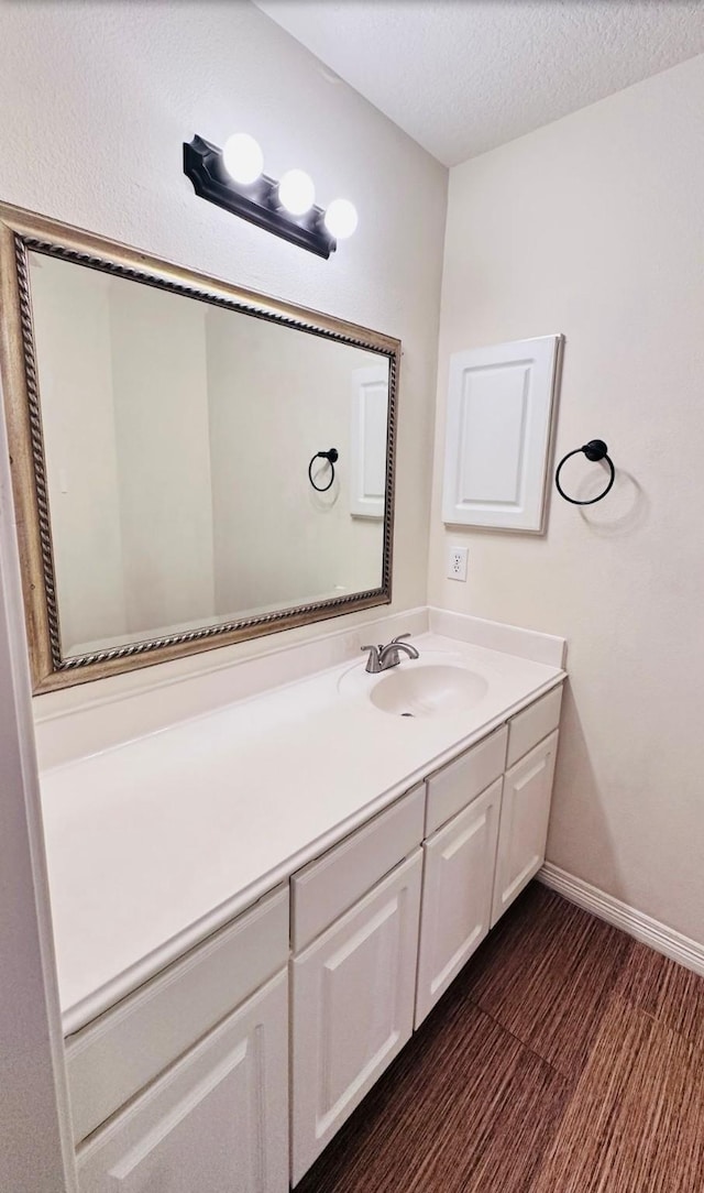 bathroom with vanity and a textured ceiling