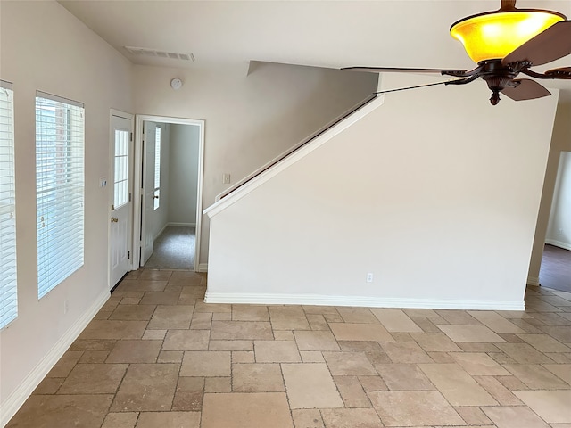 foyer entrance featuring ceiling fan