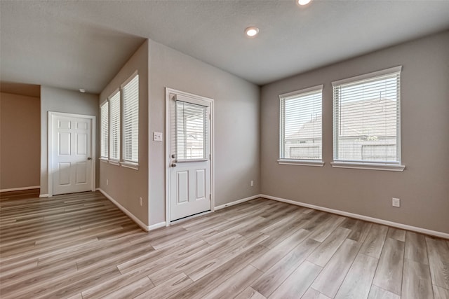 foyer entrance with light hardwood / wood-style flooring