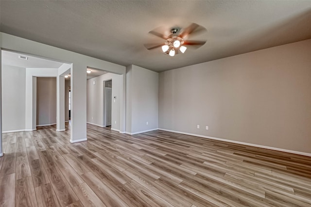 interior space featuring ceiling fan, light hardwood / wood-style flooring, and a textured ceiling