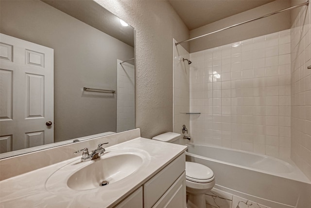 full bathroom with vanity, tiled shower / bath combo, and toilet