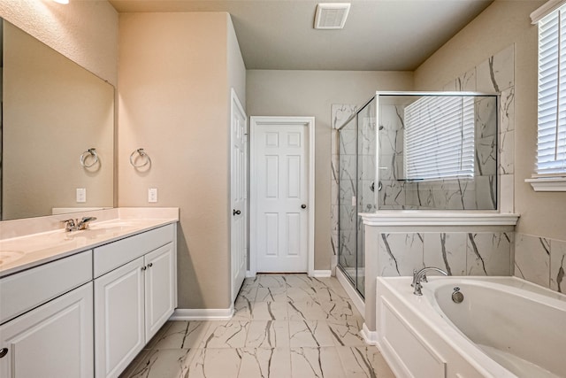 bathroom featuring shower with separate bathtub, vanity, and a wealth of natural light