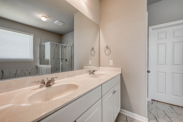 bathroom featuring a tile shower and vanity