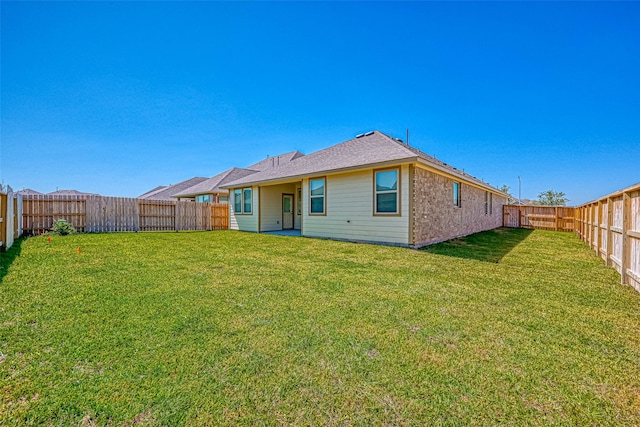 rear view of house with a lawn