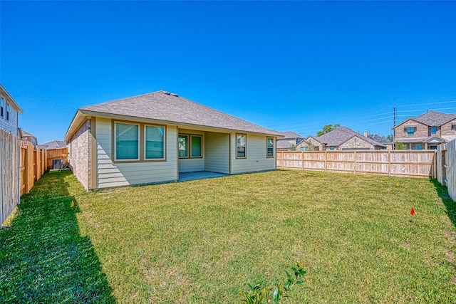 back of property featuring a patio area and a yard