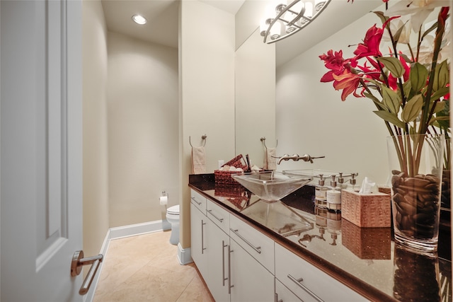 bathroom featuring tile patterned flooring, vanity, and toilet