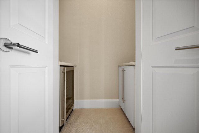 walk in closet featuring light carpet