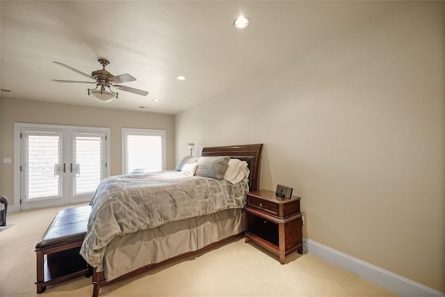 bedroom with light carpet, french doors, access to outside, and ceiling fan