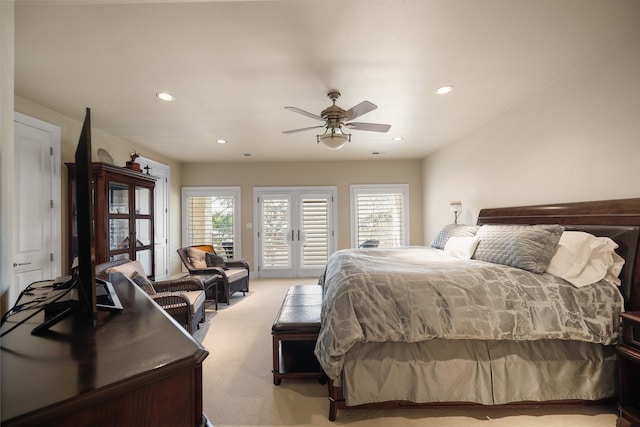 carpeted bedroom with multiple windows, ceiling fan, french doors, and access to exterior