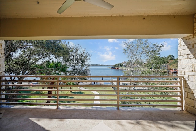 balcony featuring ceiling fan and a water view