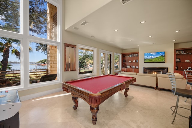 rec room featuring a wealth of natural light, a water view, and billiards