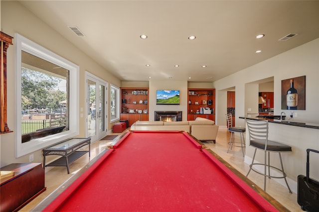 playroom with tile patterned floors, indoor bar, and pool table