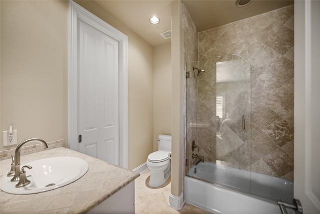 full bathroom featuring vanity, toilet, and bath / shower combo with glass door