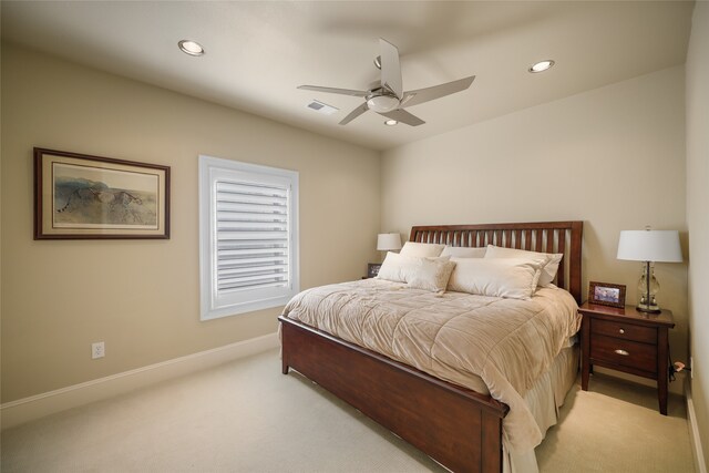 bedroom with ceiling fan and light carpet