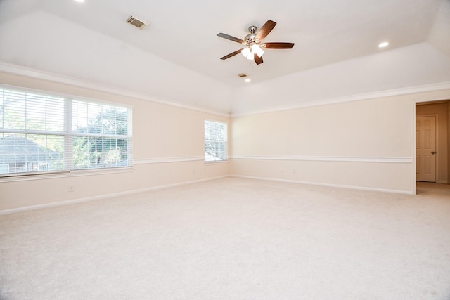 carpeted empty room with ceiling fan, crown molding, and vaulted ceiling