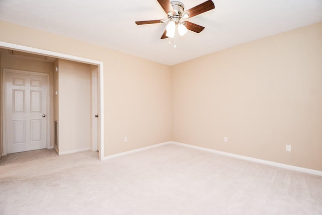 carpeted empty room featuring ceiling fan