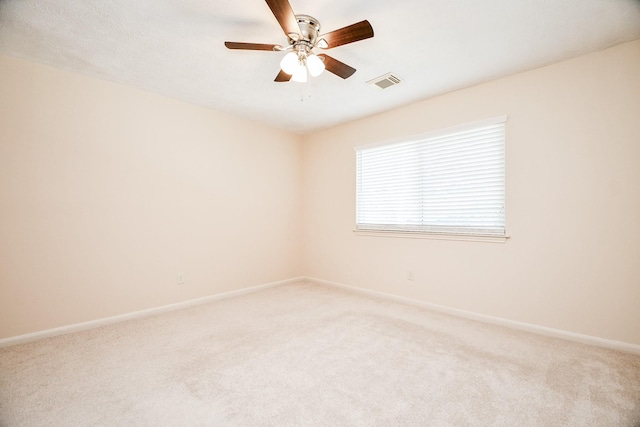 carpeted empty room featuring ceiling fan