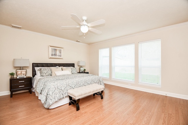 bedroom with ceiling fan, crown molding, and light hardwood / wood-style floors