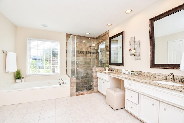 bathroom with tile patterned flooring, vanity, and separate shower and tub