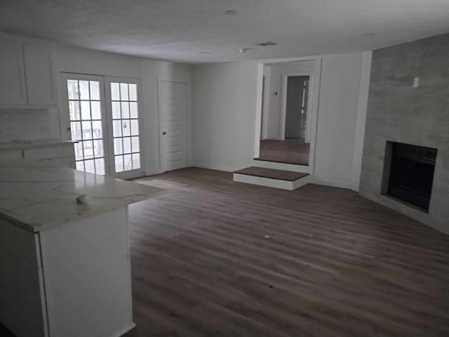 unfurnished living room featuring dark hardwood / wood-style flooring