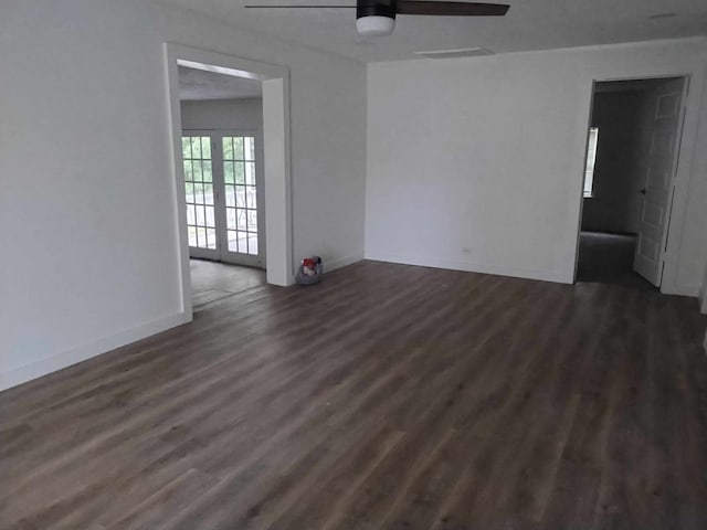 unfurnished room featuring ceiling fan, french doors, and dark wood-type flooring