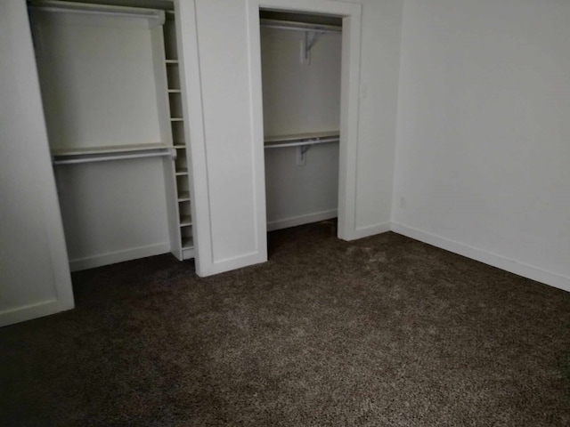 unfurnished bedroom with dark carpet