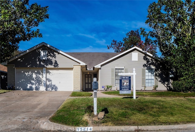 single story home with a garage and a front lawn