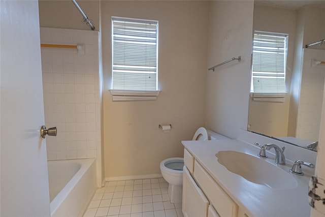 full bathroom featuring toilet, vanity, tile patterned floors, and tiled shower / bath combo