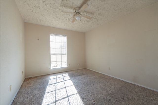 unfurnished room with carpet flooring, ceiling fan, and a textured ceiling