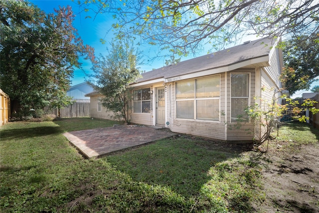 rear view of property with a patio area and a yard