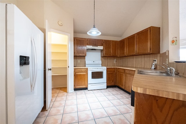 kitchen with pendant lighting, lofted ceiling, white appliances, sink, and tasteful backsplash