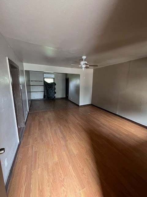 unfurnished living room with hardwood / wood-style floors and ceiling fan