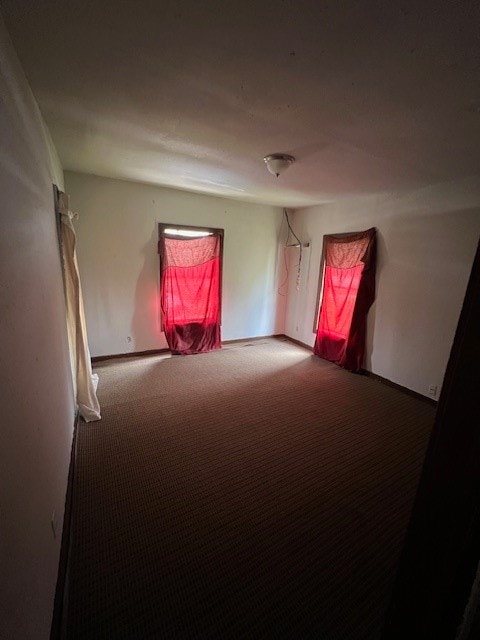 unfurnished room featuring carpet