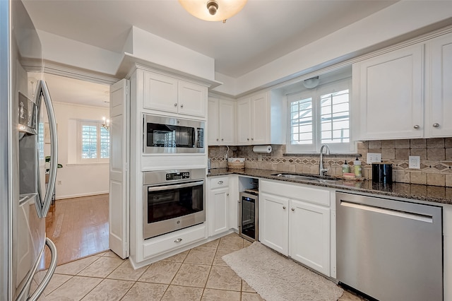 kitchen featuring white cabinetry, a wealth of natural light, and stainless steel appliances