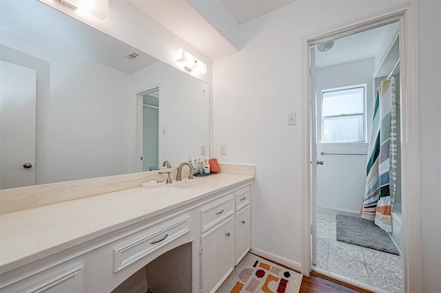 bathroom with hardwood / wood-style floors and vanity