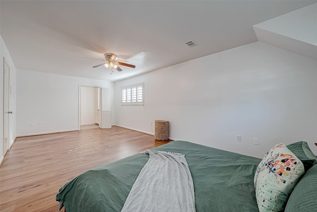 bedroom with ceiling fan, light hardwood / wood-style floors, and lofted ceiling