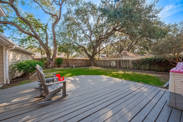 wooden terrace featuring a lawn